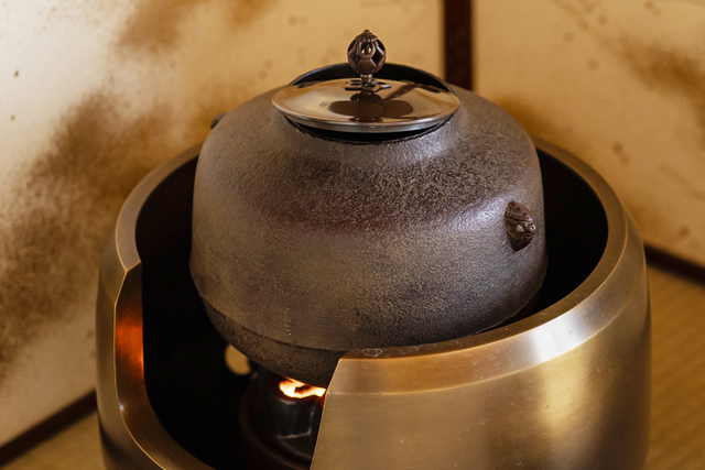 A traditional cast-iron kettle (Chagama) in a Japanese tea room